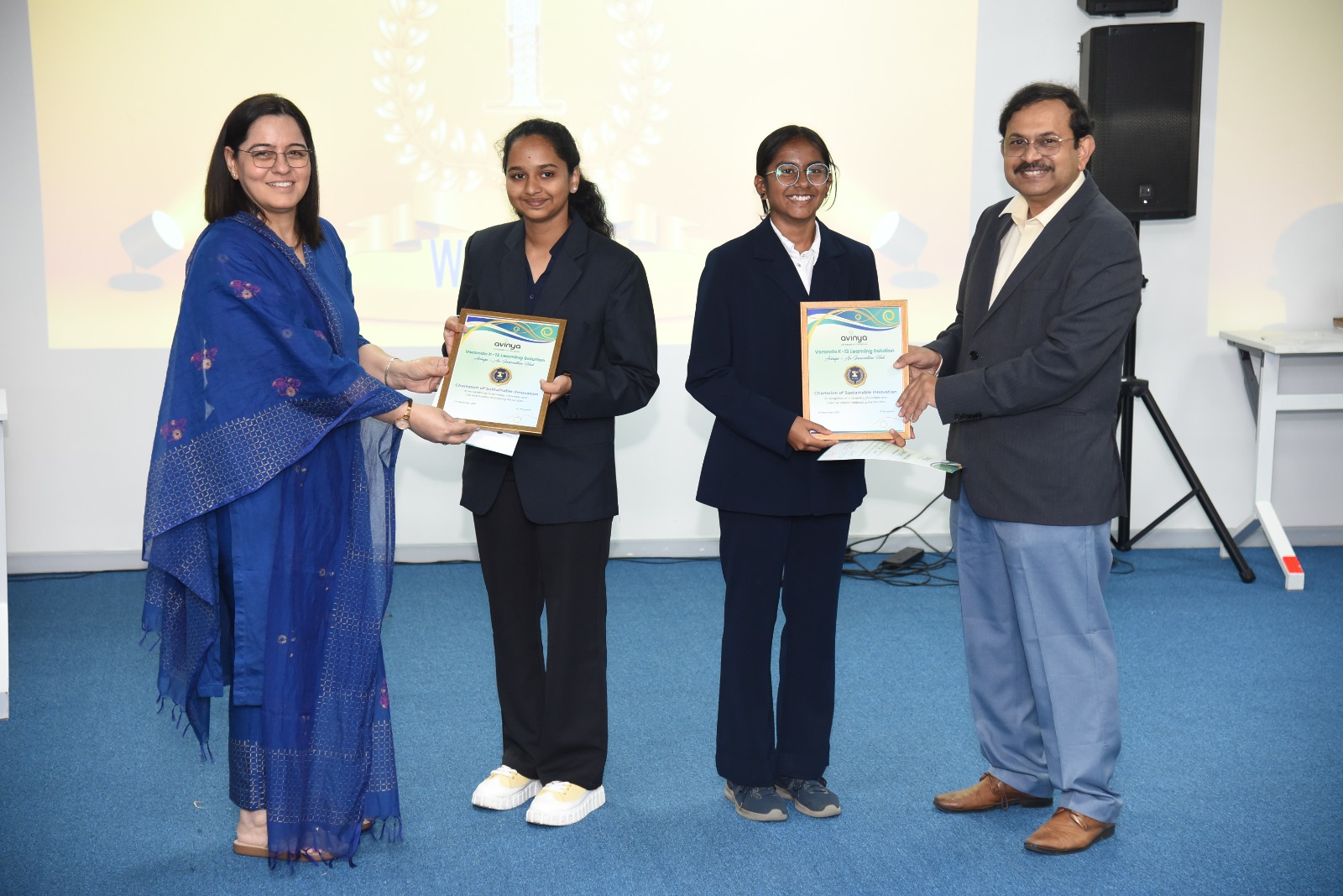 Rohini Mahajan (left), Cluster Head – Operations, Veranda K-12, Chitrashree C (second from left) and Divyanshi Soo (centre) from Deeksha STEM School, Bengaluru and Prof. Debabrata Das, Director, IIIT-Bangalore